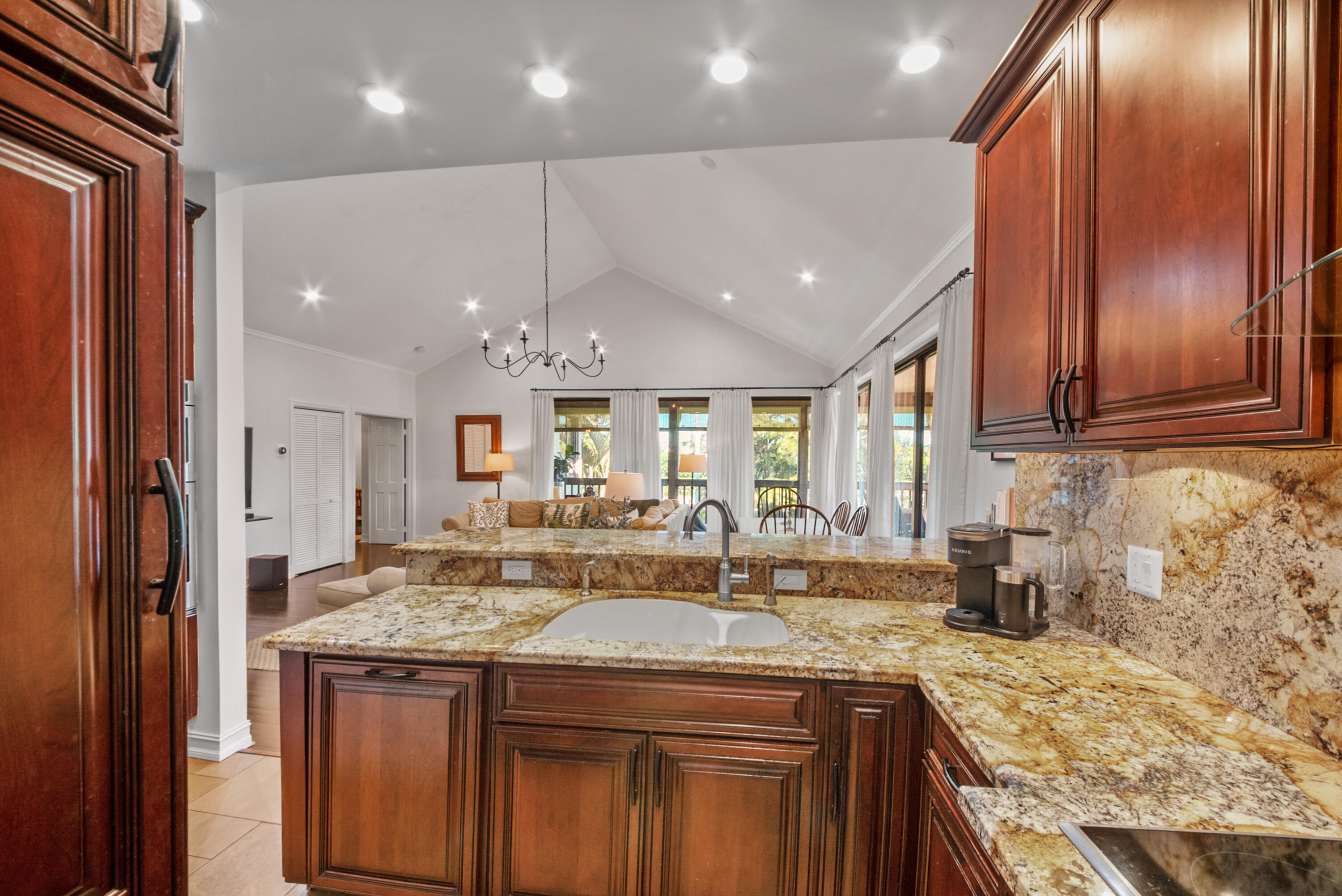 19199 Sabal Lake Drive Boca Raton, FL 33434 - Photo 11 of 40 a kitchen with kitchen island granite countertop a sink and cabinets