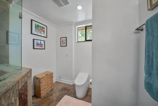 a bathroom with a granite countertop sink a shower and a mirror