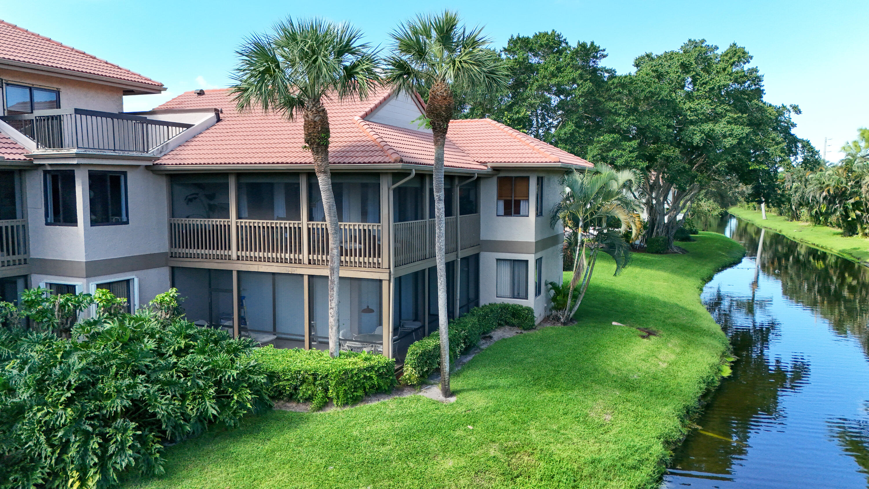 19199 Sabal Lake Drive Boca Raton, FL 33434 - Photo 2 of 40 a front view of a house with a yard