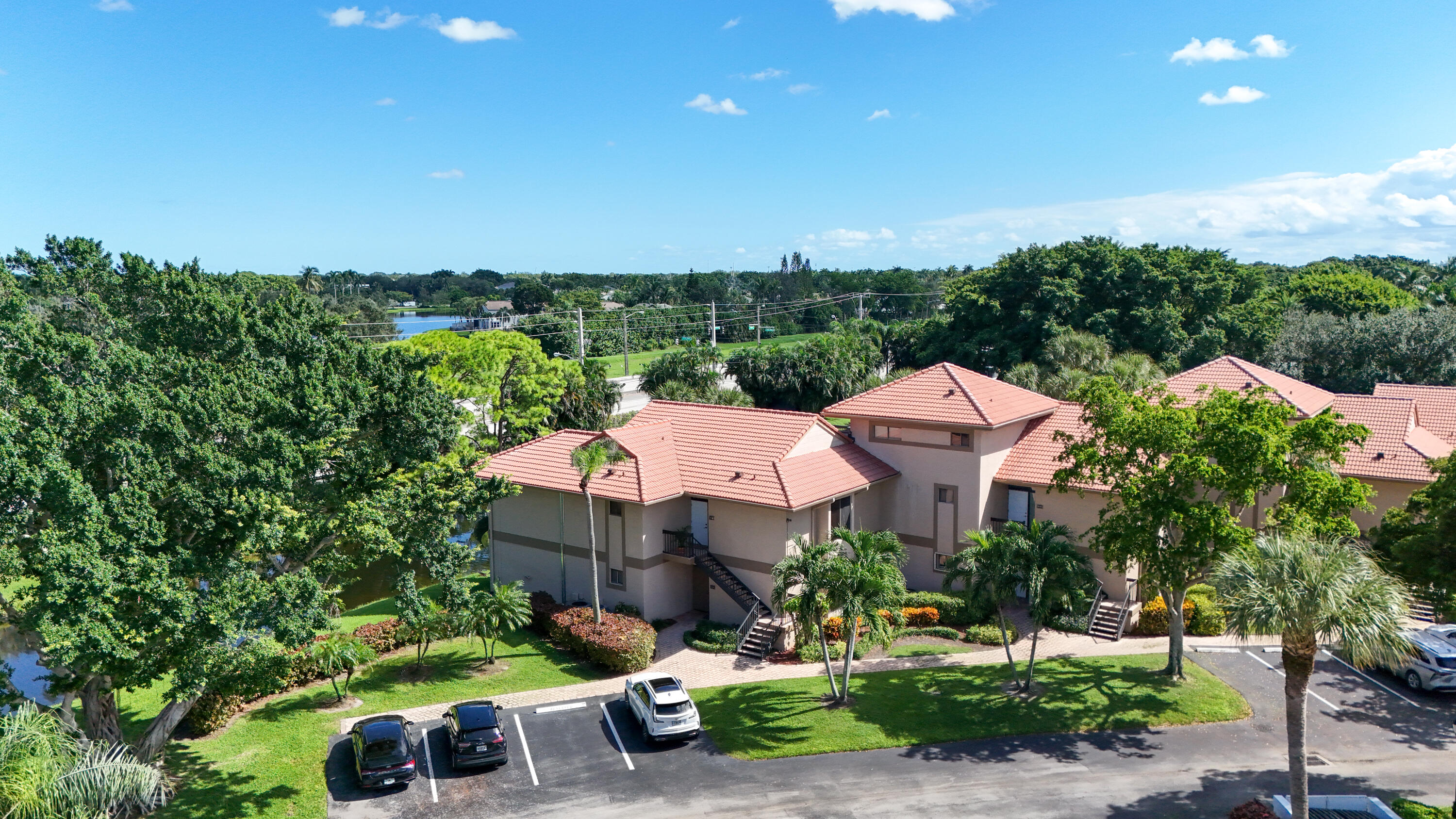 19199 Sabal Lake Drive Boca Raton, FL 33434 - Photo 27 of 40 a front view of a house with garden space and street view
