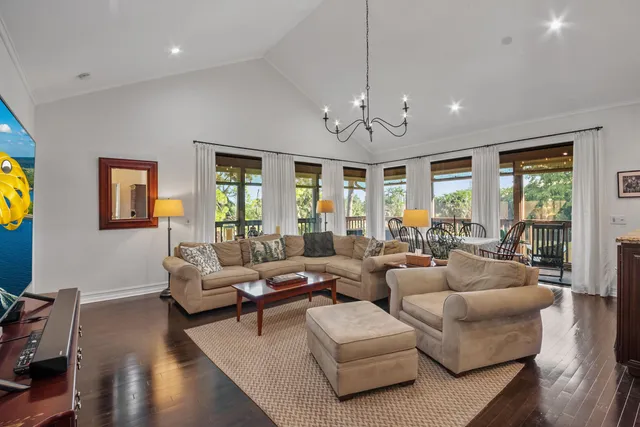 a living room with furniture ceiling fan and a window