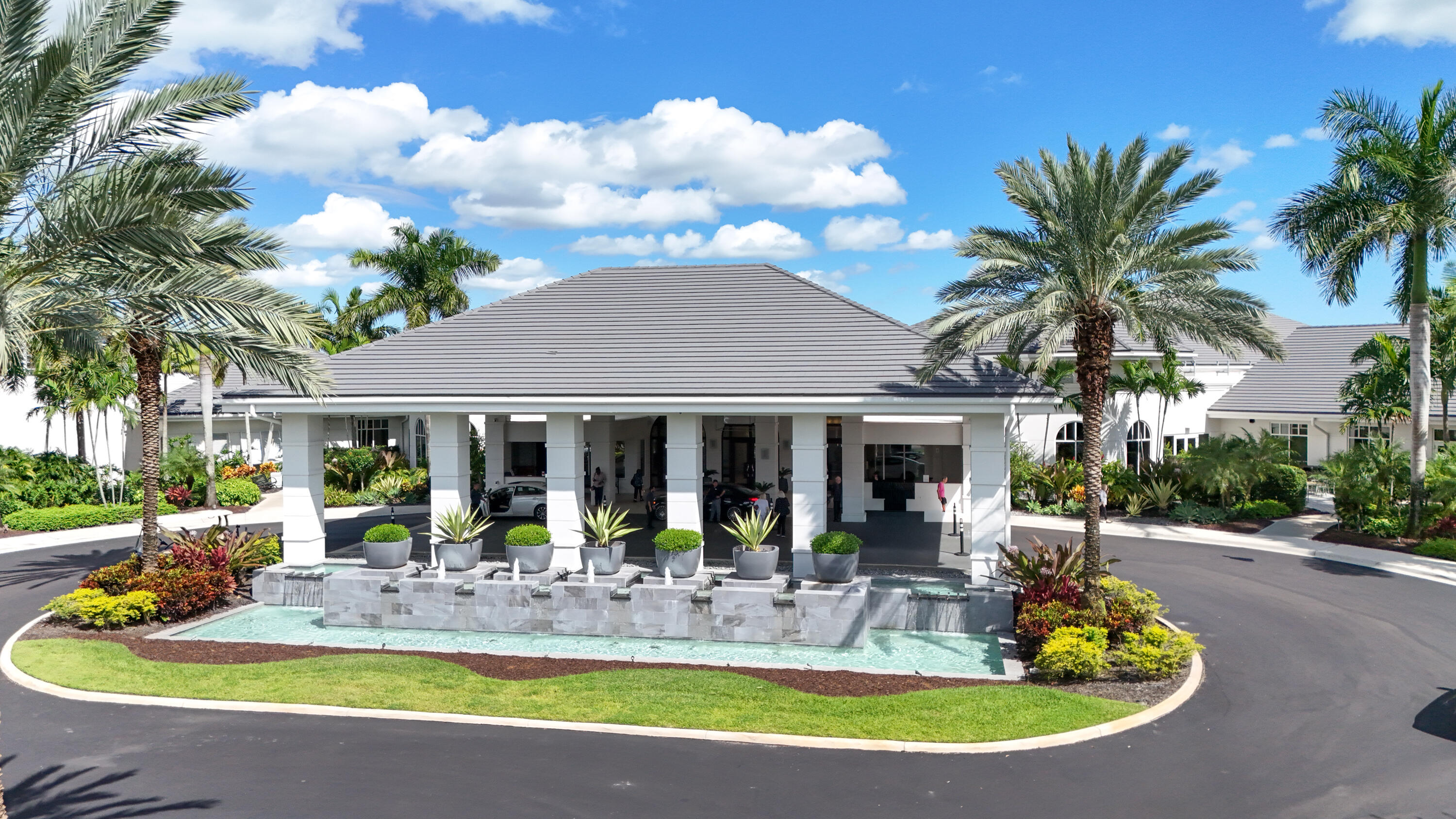 19199 Sabal Lake Drive Boca Raton, FL 33434 - Photo 32 of 40 a view of a house with swimming pool and a dining table and chairs under an umbrella