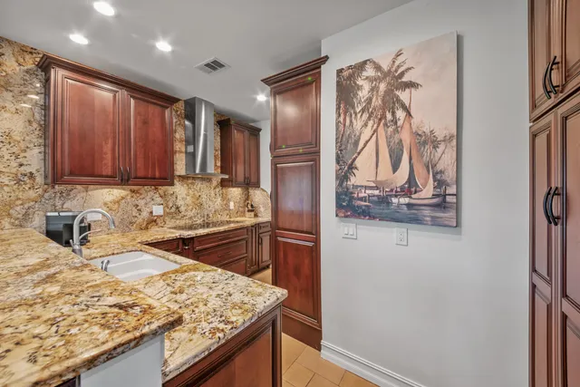 a kitchen with stainless steel appliances granite countertop a refrigerator and a sink