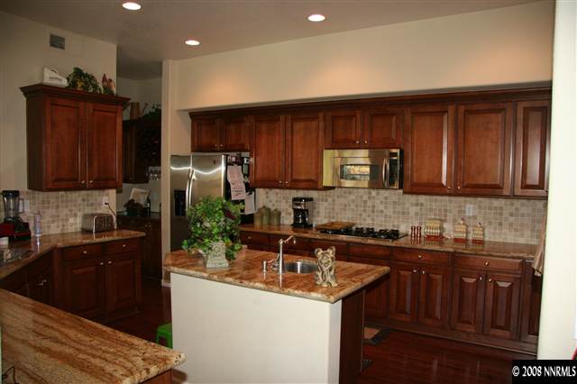 1615 Silver Thread Drive Reno, NV 89521 - Photo 2 of 9 a kitchen with a sink and a refrigerator