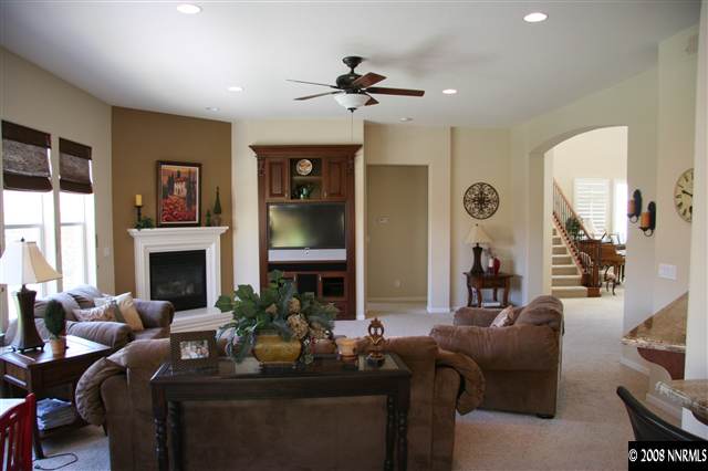 1615 Silver Thread Drive Reno, NV 89521 - Photo 5 of 9 a living room with furniture a large window and a fireplace