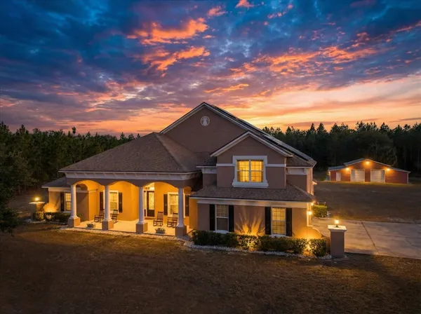 an aerial view of river residential houses with outdoor space and swimming pool