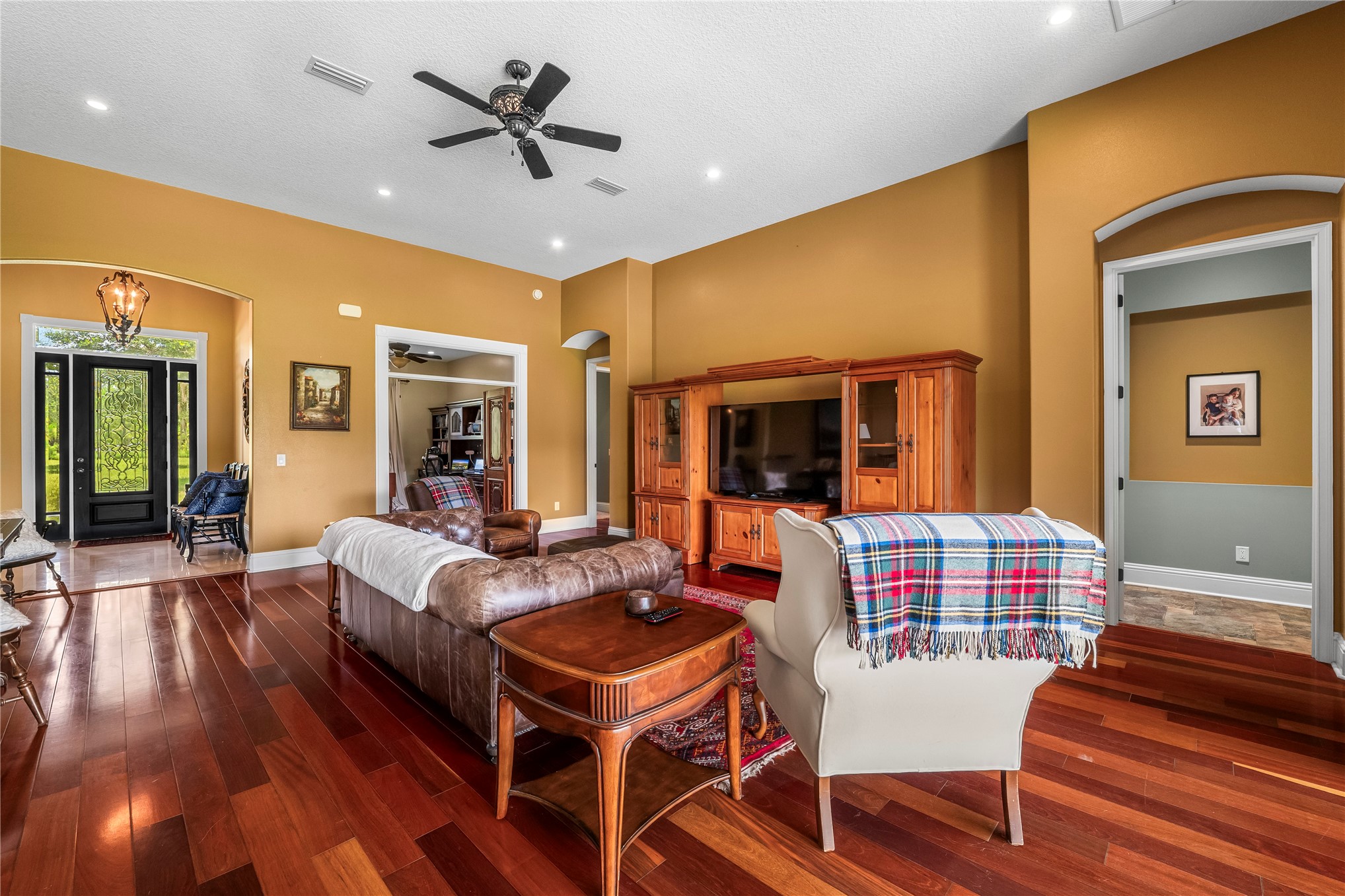 27247 Hallman Road Hilliard, FL 32046 - Photo 17 of 59 a living room with furniture a flat screen tv and a table