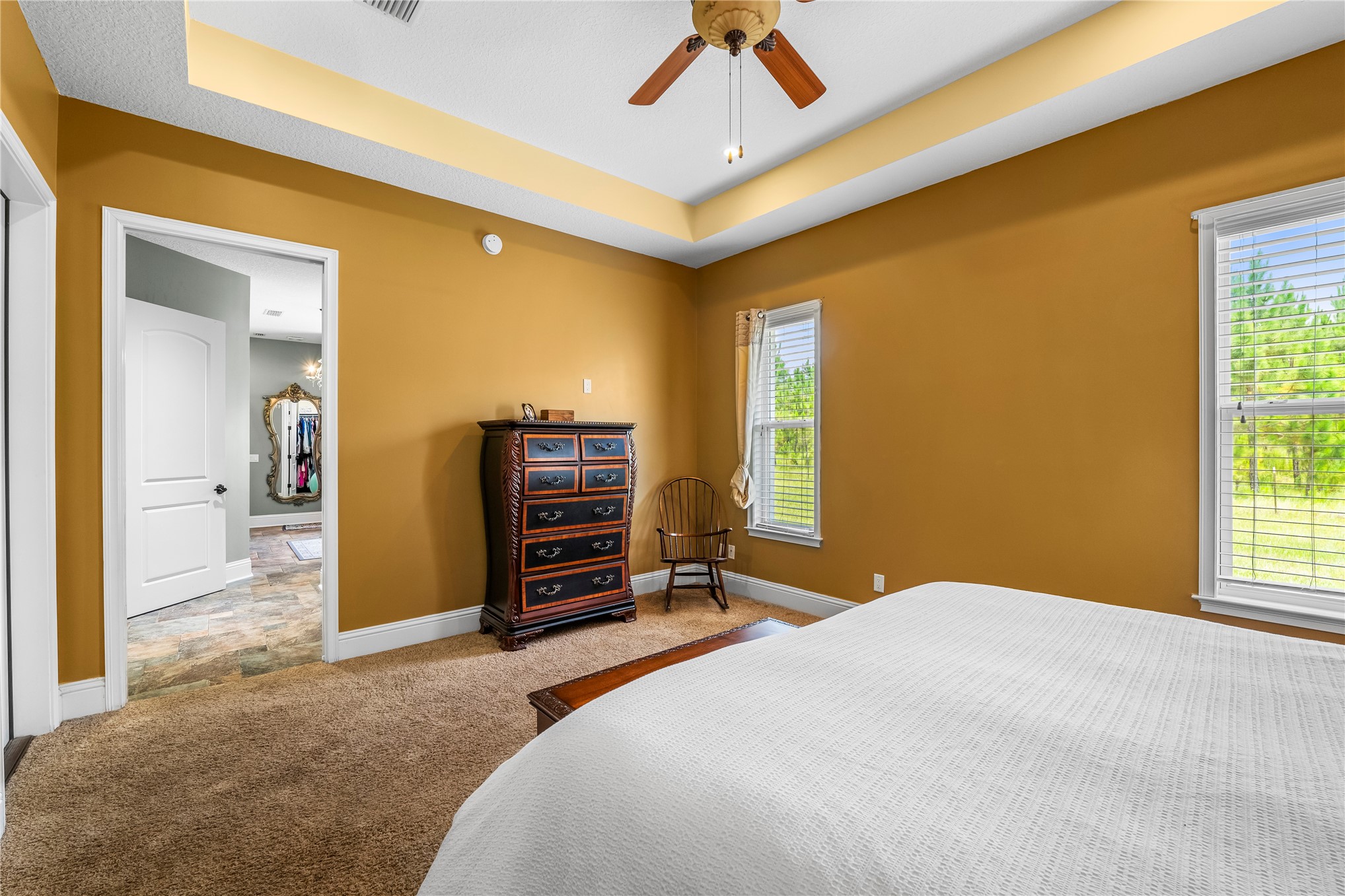 27247 Hallman Road Hilliard, FL 32046 - Photo 27 of 59 a bedroom with a bed and a chandelier