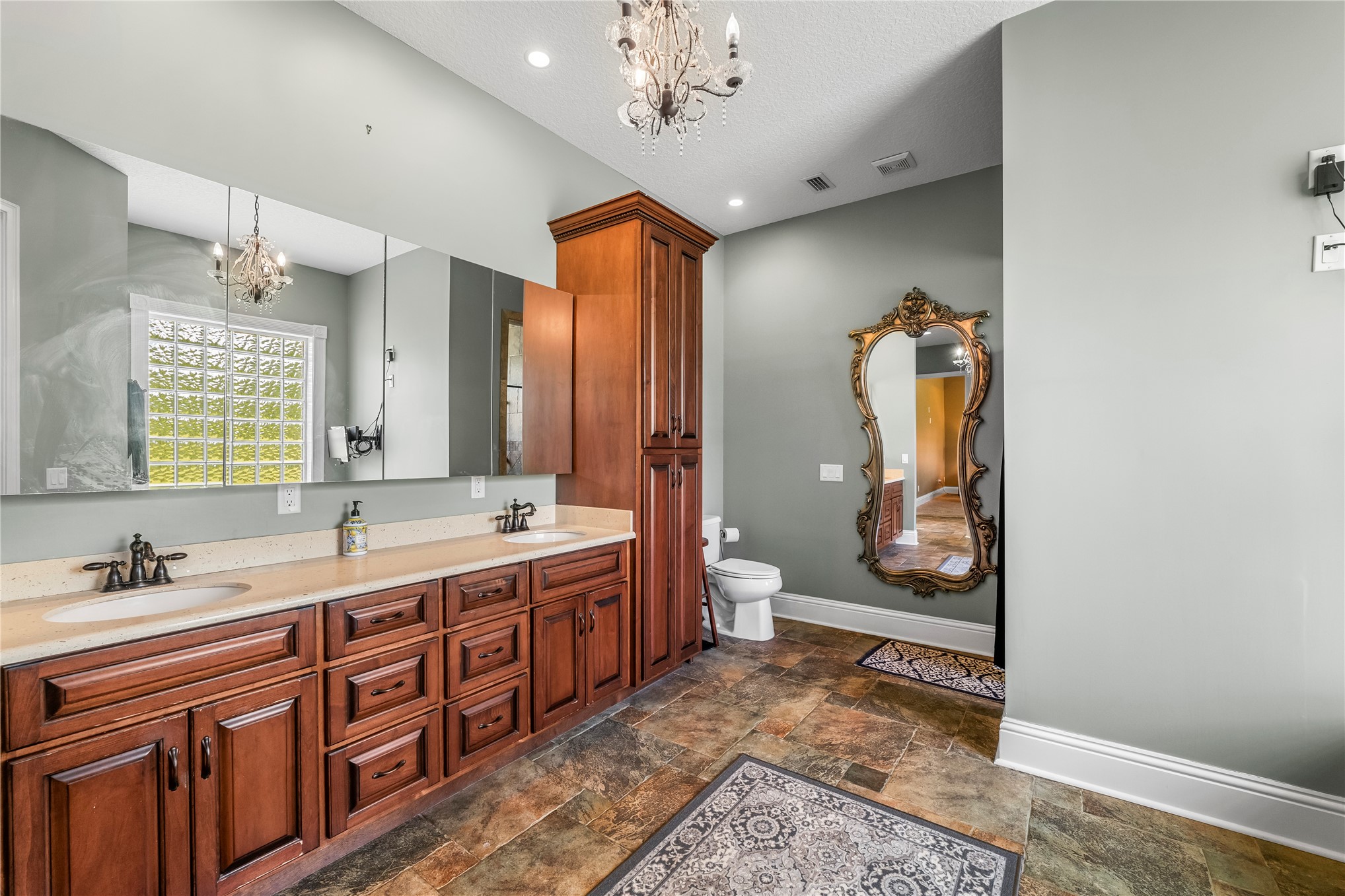 27247 Hallman Road Hilliard, FL 32046 - Photo 32 of 59 a spacious bathroom with a granite countertop sink mirror and a toilet