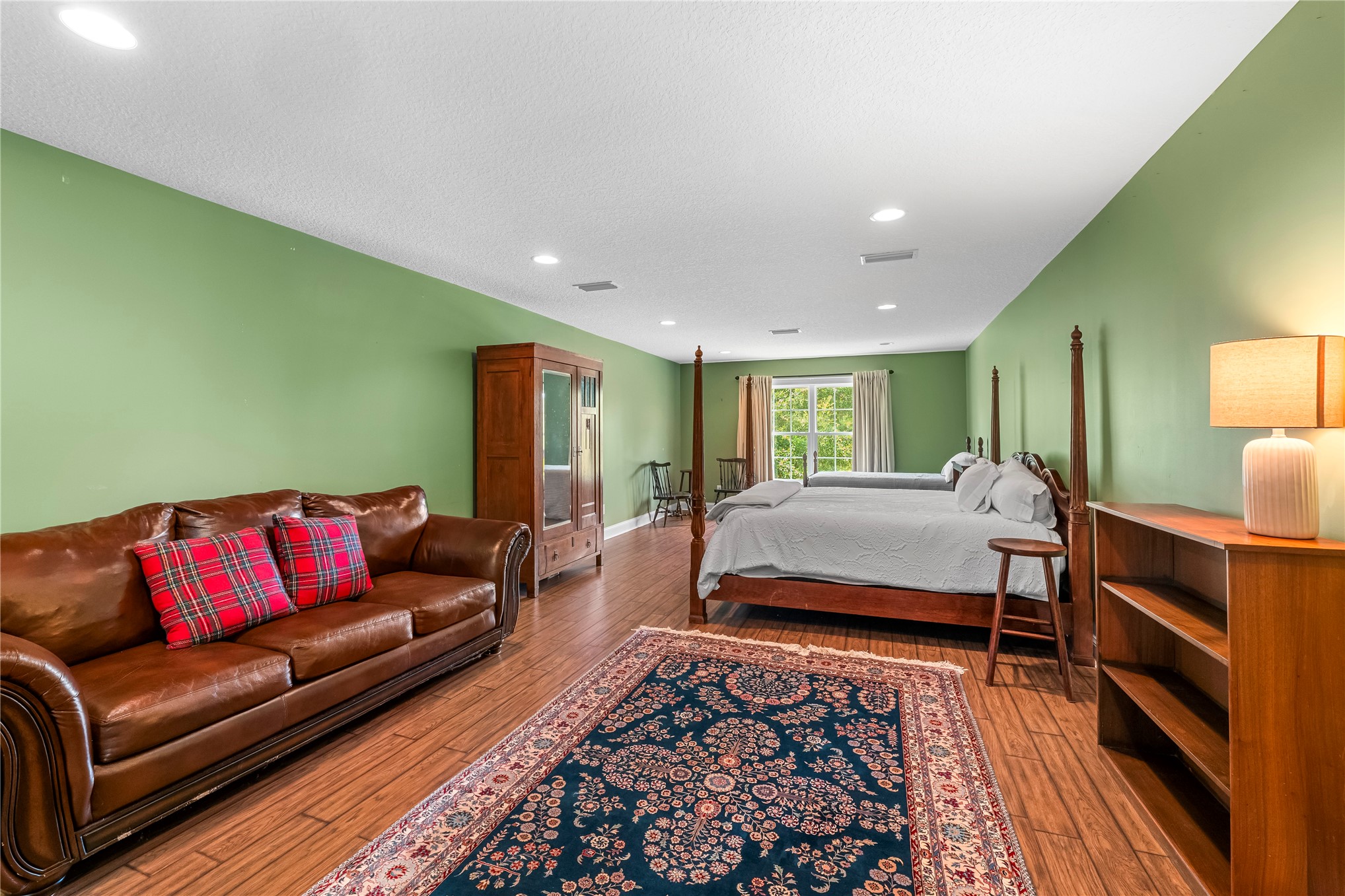 27247 Hallman Road Hilliard, FL 32046 - Photo 49 of 59 a spacious bedroom with a bed and a couch