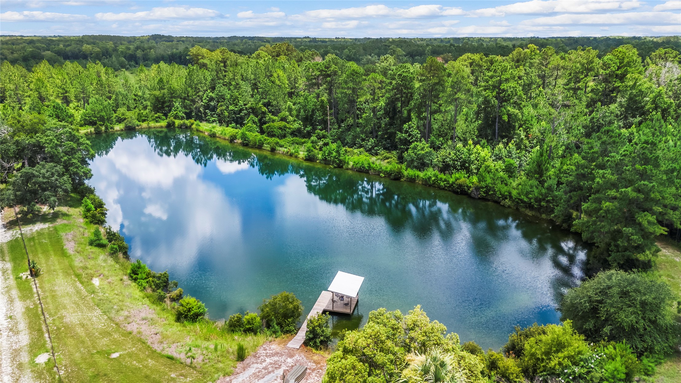 27247 Hallman Road Hilliard, FL 32046 - Photo 52 of 59 an aerial view of a house with a yard and lake view