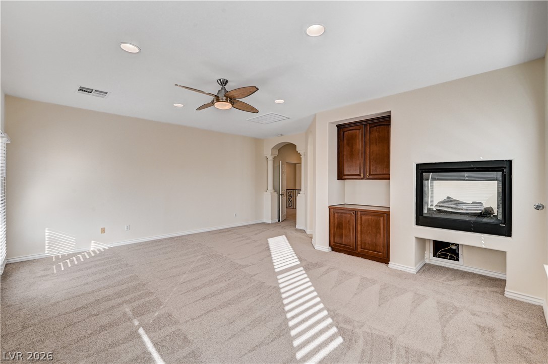 6761 Clay TABLET Street Las Vegas, NV 89149 - Photo 37 of 73 Plush carpeting and a built-in fireplace accent this versatile second-story loft space.