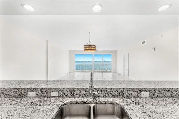 a view of a kitchen with a sink and a chandelier