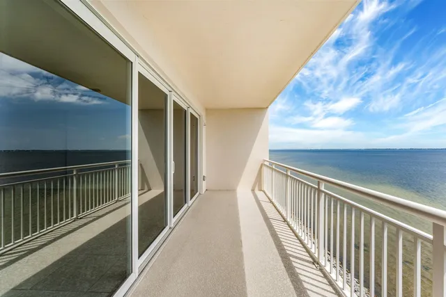 an empty room with closet and windows