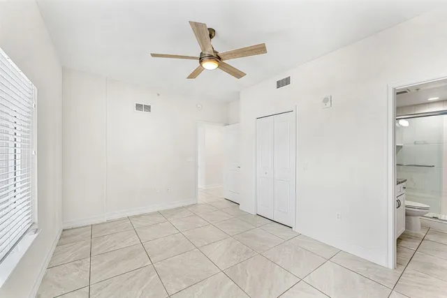 a bathroom with a granite countertop bathtub sink and mirror