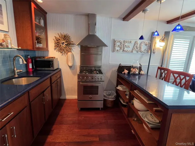 a kitchen with stainless steel appliances a stove a sink and a refrigerator