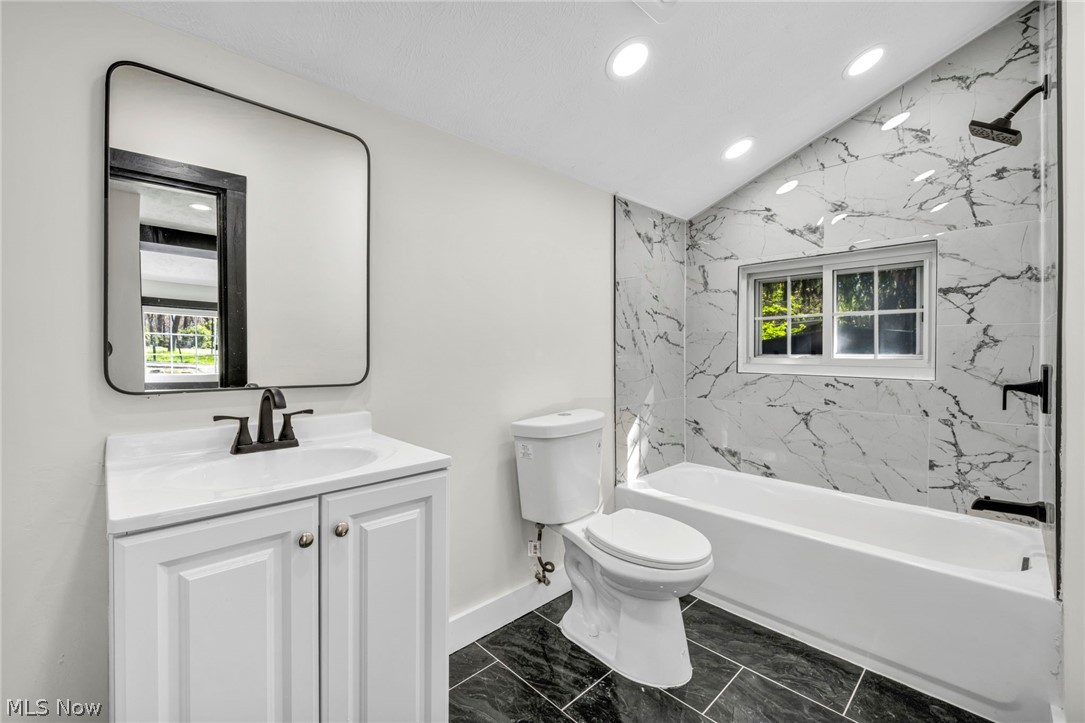 7339 River Road Olmsted Falls, OH 44138 - Photo 25 of 45 Bathroom featuring a white vanity with a single sink, black faucet, and a black-framed mirror