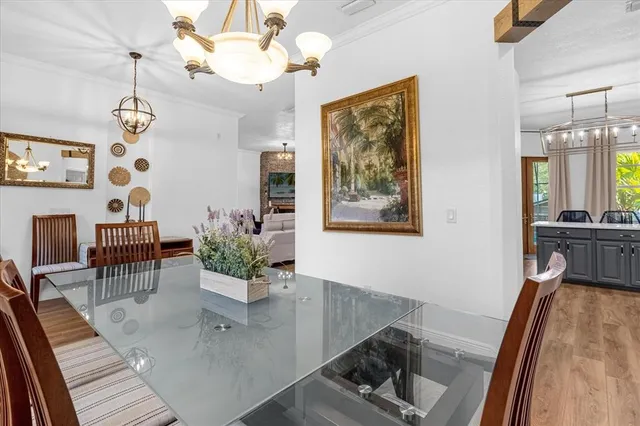 a large kitchen with stainless steel appliances a stove center island a cabinets wooden floor and a window