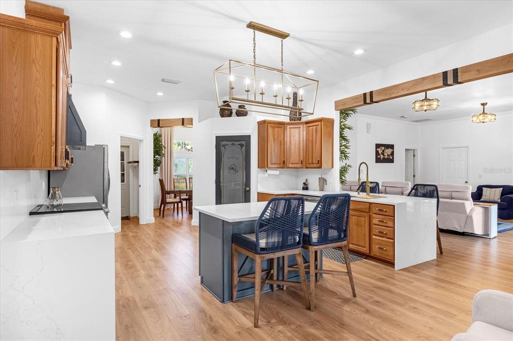 2975 West Osceola Road Geneva, FL 32732 - Photo 18 of 45 a kitchen with stainless steel appliances kitchen island granite countertop a table chairs and a refrigerator