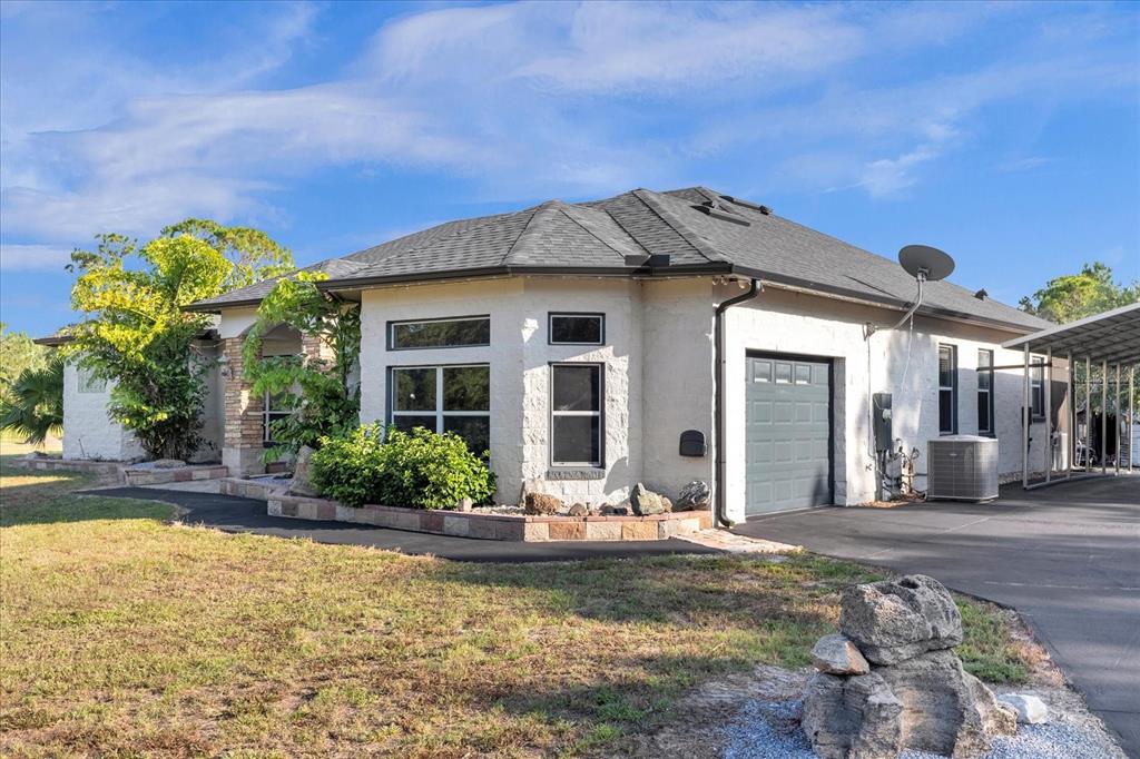 2975 West Osceola Road Geneva, FL 32732 - Photo 2 of 45 a front view of a house with garden
