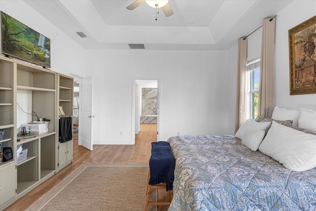 2975 West Osceola Road Geneva, FL 32732 - Photo 24 of 45 a bedroom with a bed and a chandelier