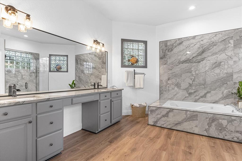 2975 West Osceola Road Geneva, FL 32732 - Photo 26 of 45 a spacious bathroom with a double vanity sink a mirror and a bathtub