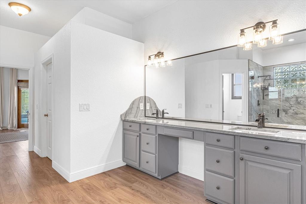 2975 West Osceola Road Geneva, FL 32732 - Photo 29 of 45 a spacious bathroom with a double vanity sink and a mirror