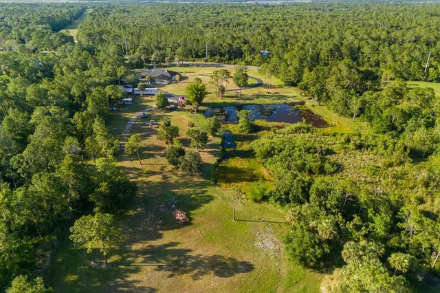 a aerial view of residential houses with yard and swimming pool