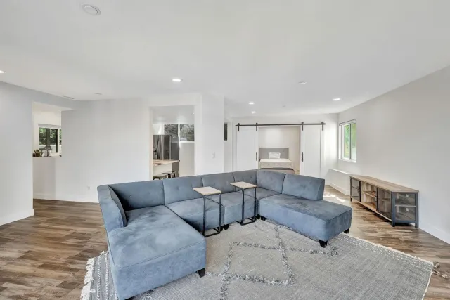 a living room with furniture and a wooden floor