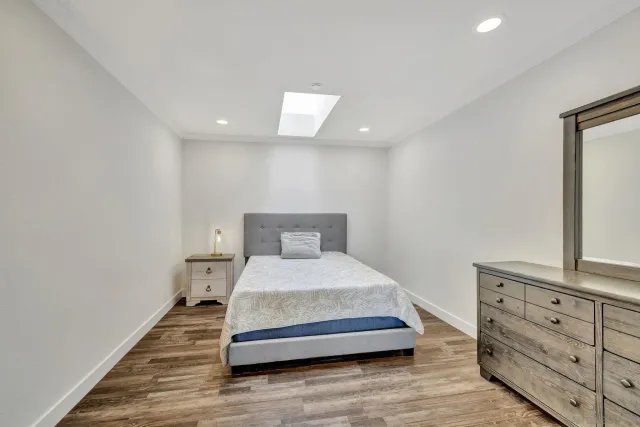 a bedroom with a bed and a dresser