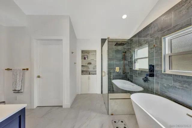a bathroom with a tub shower and sink