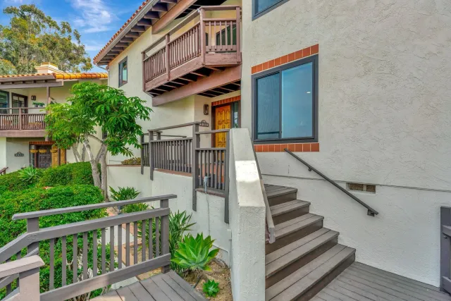 a view of a house with wooden fence and windows