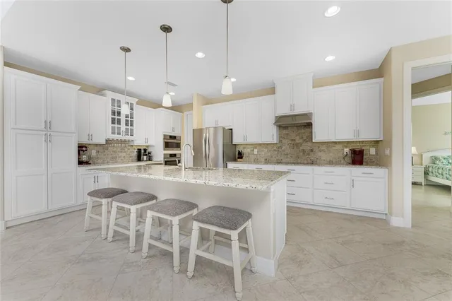 a large kitchen with a table and chairs
