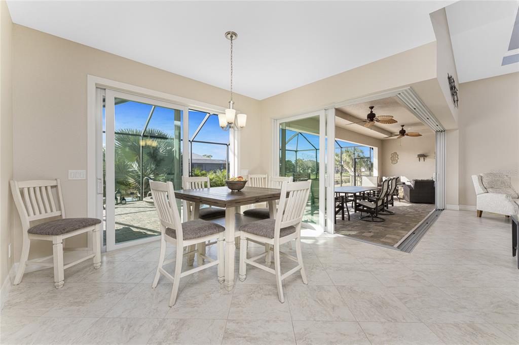 199 Marker Road Rotonda West, FL 33947 - Photo 15 of 55 a dining room with furniture water view and a floor to ceiling window