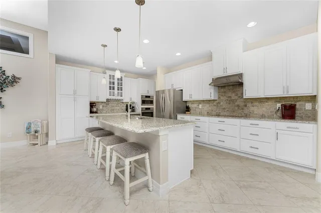 a kitchen with refrigerator and cabinets