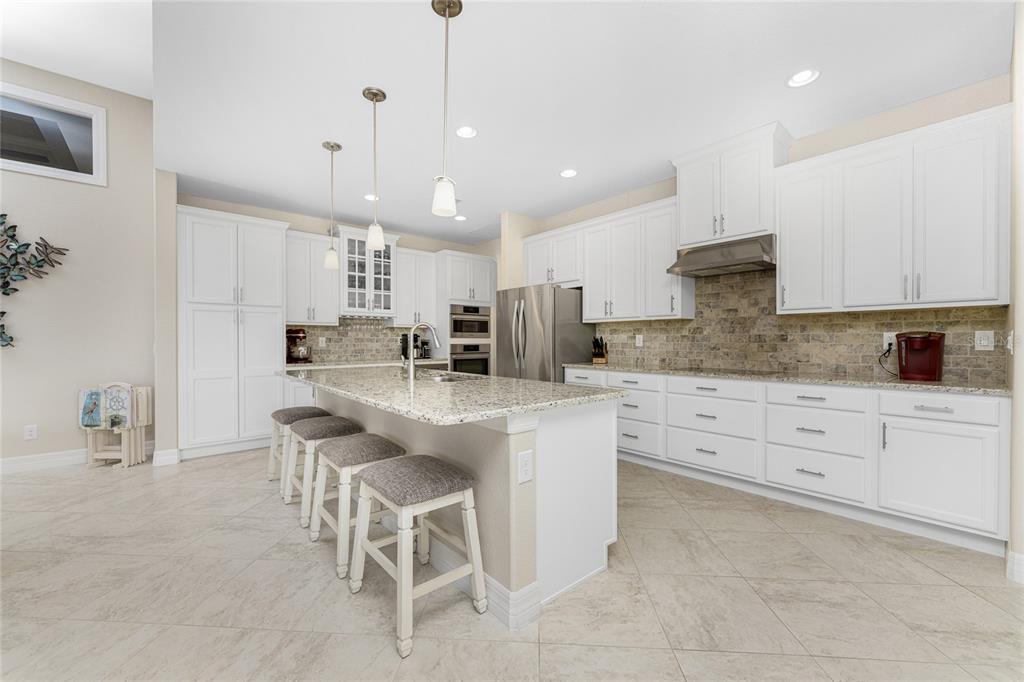 199 Marker Road Rotonda West, FL 33947 - Photo 16 of 55 a kitchen with kitchen island granite countertop a sink a center island and appliances