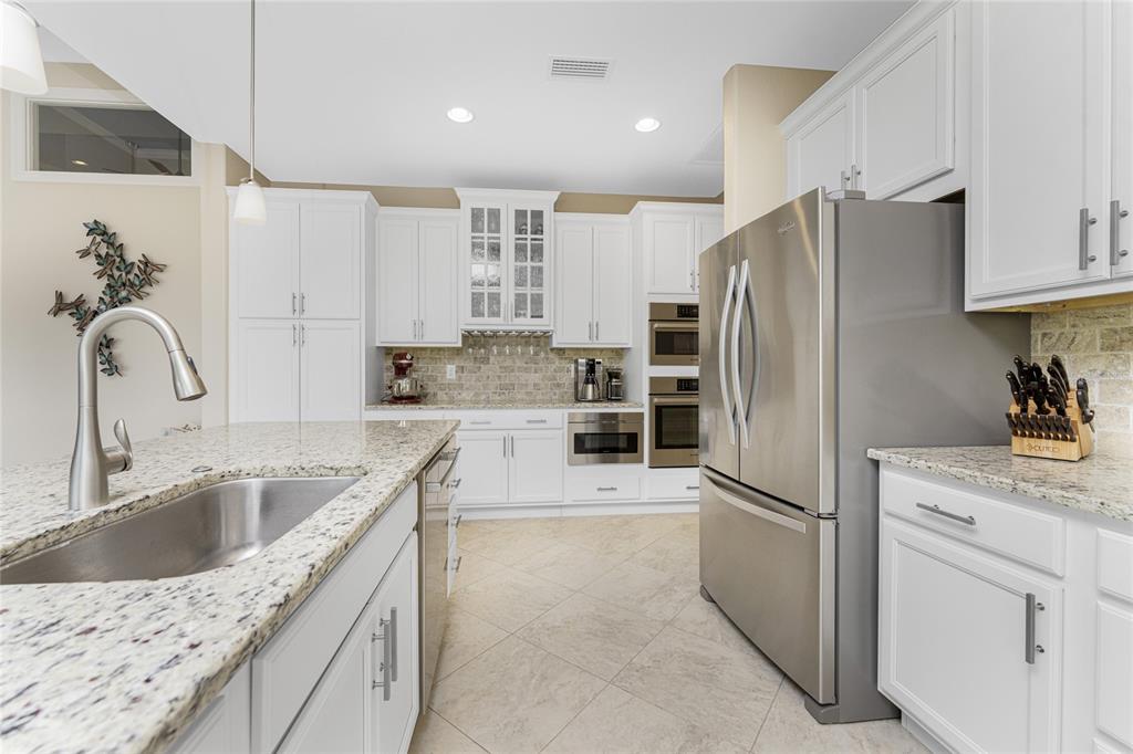 199 Marker Road Rotonda West, FL 33947 - Photo 20 of 55 a kitchen with a sink refrigerator and cabinets