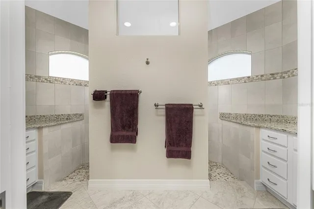 a bathroom with a granite countertop sink a toilet and a mirror