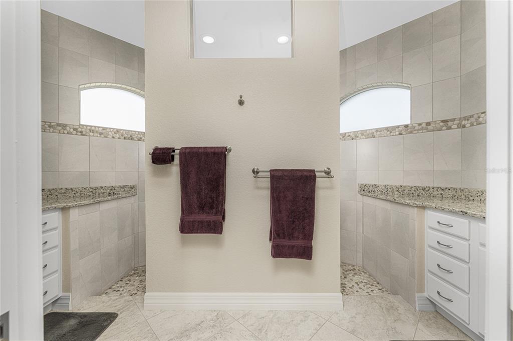 199 Marker Road Rotonda West, FL 33947 - Photo 24 of 55 a bathroom with a granite countertop sink a mirror and vanity