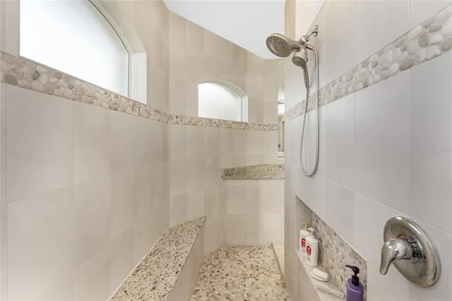 a spacious bathroom with a shower and a sink