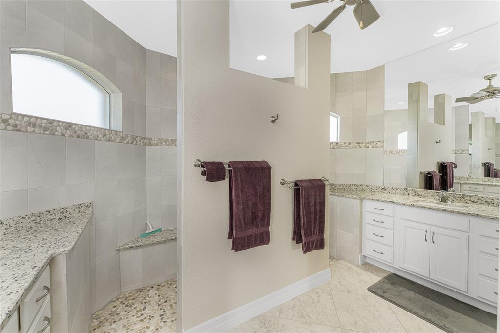 199 Marker Road Rotonda West, FL 33947 - Photo 26 of 55 a bathroom with a granite countertop sink a toilet and a mirror
