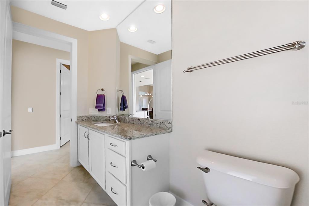 199 Marker Road Rotonda West, FL 33947 - Photo 31 of 55 a spacious bathroom with a granite countertop sink and a mirror