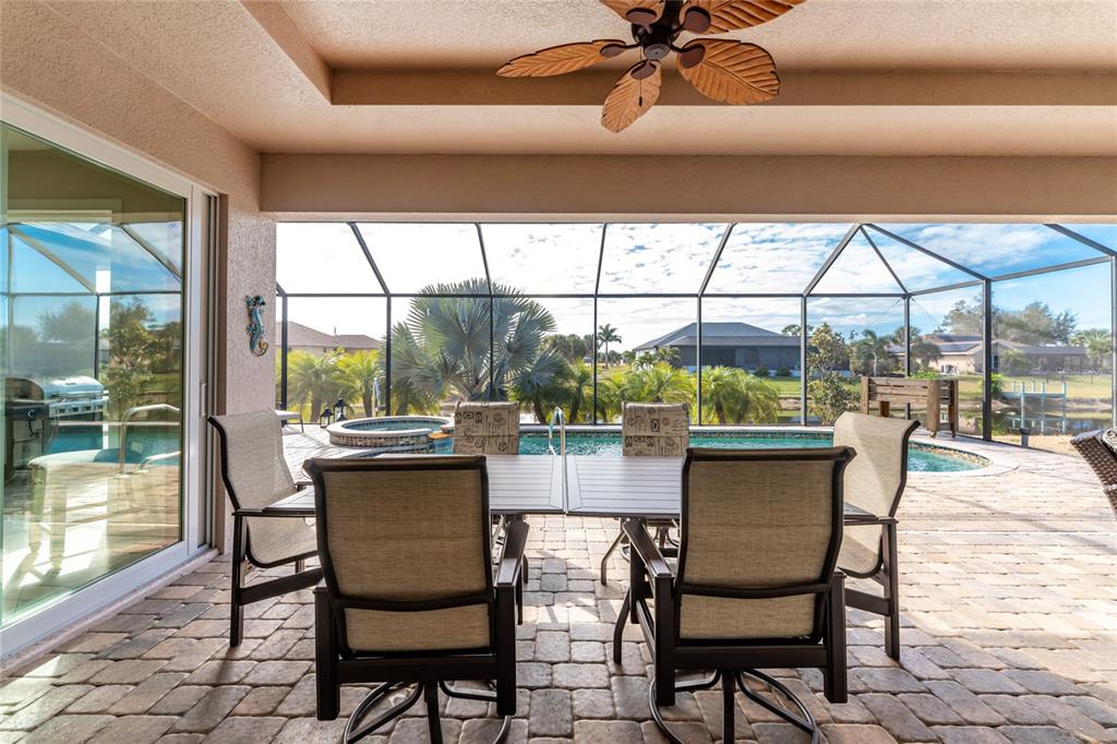 199 Marker Road Rotonda West, FL 33947 - Photo 40 of 55 a dining room with furniture a chandelier and fireplace
