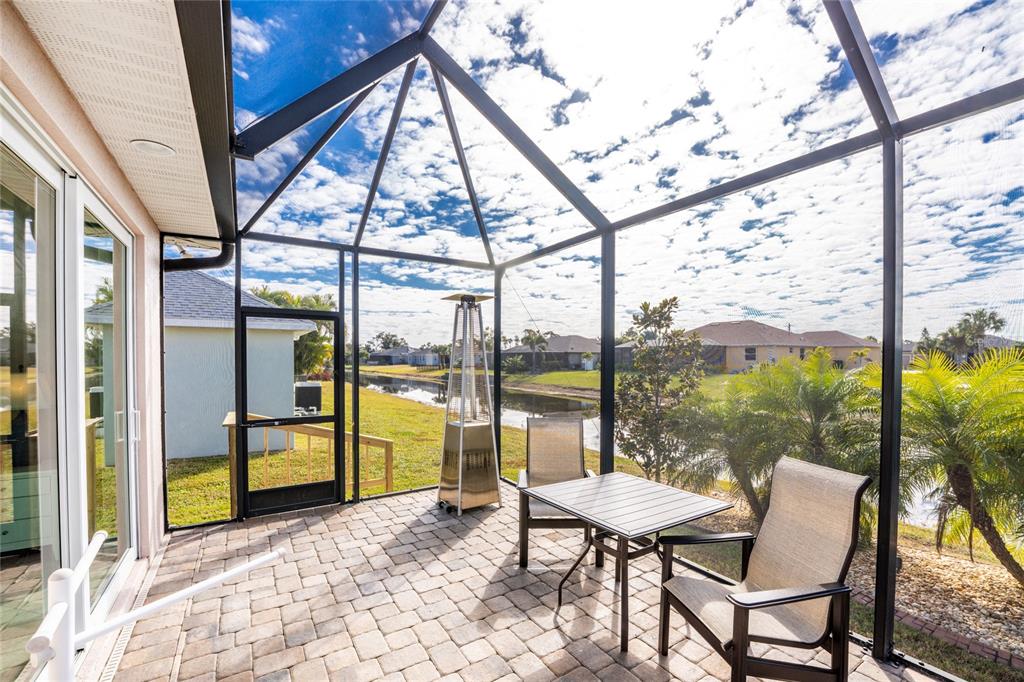 199 Marker Road Rotonda West, FL 33947 - Photo 44 of 55 a view of a chairs and table in the patio with a backyard