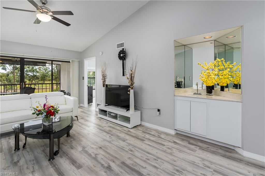 905 Augusta Boulevard, Unit 7 Naples, FL 34113 - Photo 1 of 42 a living room with furniture and a flat screen tv