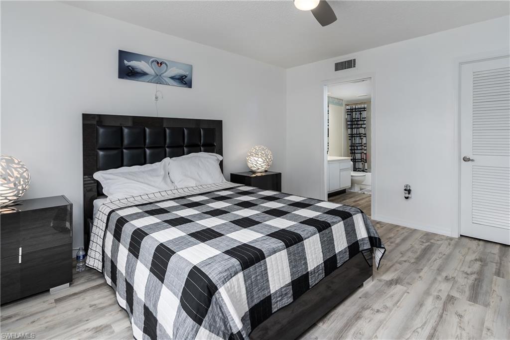 905 Augusta Boulevard, Unit 7 Naples, FL 34113 - Photo 14 of 42 a bedroom with a bed and a window