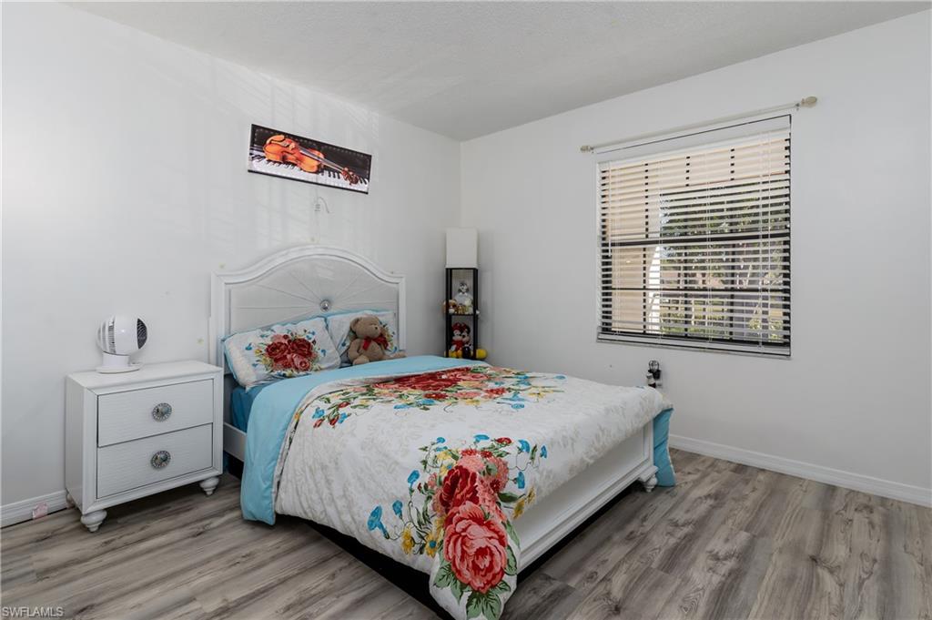 905 Augusta Boulevard, Unit 7 Naples, FL 34113 - Photo 16 of 42 a bed sitting in a bedroom next to a window