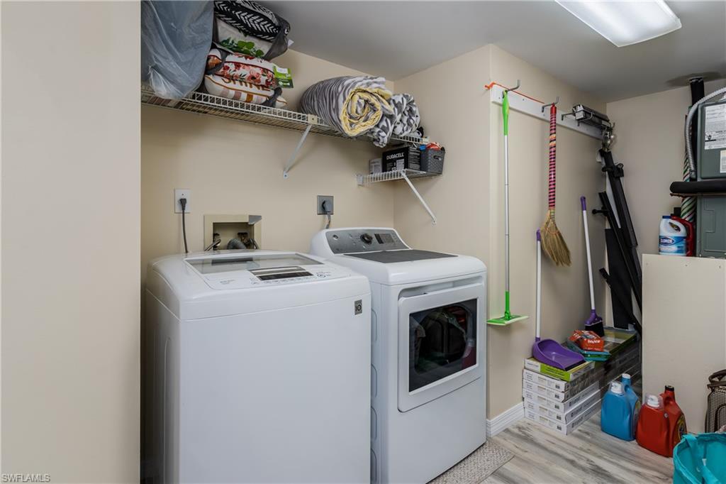 905 Augusta Boulevard, Unit 7 Naples, FL 34113 - Photo 19 of 42 a view of walk in closet with clothes and shoes