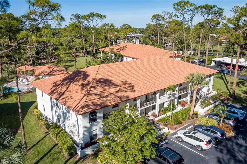 905 Augusta Boulevard, Unit 7 Naples, FL 34113 - Photo 20 of 42 a view of a swimming pool with a yard