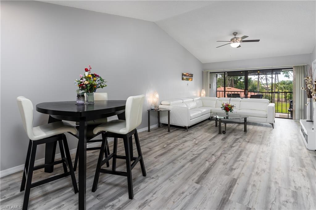 905 Augusta Boulevard, Unit 7 Naples, FL 34113 - Photo 2 of 42 a living room with furniture and a large window